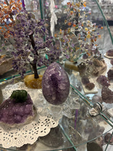 Load image into Gallery viewer, Close-up of Brazilian amethyst geode egg interior revealing natural purple crystal formations and polished finish