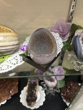 Load image into Gallery viewer, Close-up of Uruguay agate geode egg interior revealing sparkling druzy crystals and natural patterns