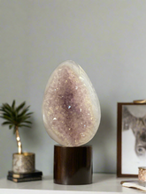 Load image into Gallery viewer, Close-up of agate geode egg displaying natural crystal formations and unique banding patterns
