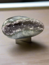 Load image into Gallery viewer, Close-up of agate geode egg interior revealing unique mineral patterns and polished surface detail