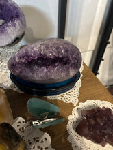 Load image into Gallery viewer, Close-up of polished amethyst geode egg interior revealing natural crystal points and purple formations