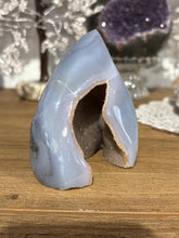 Load image into Gallery viewer, Detail view of polished Brazilian agate flame displaying crystal druzy formations and serene light blue color variations