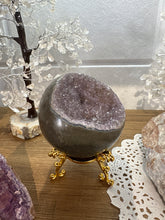 Load image into Gallery viewer, Side angle view of hand-polished amethyst geode bowl displaying lavender and purple crystal formations with natural bowl shape