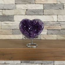 Load image into Gallery viewer, Side view of natural purple amethyst heart showing crystal formation and polished finish
