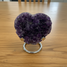 Load image into Gallery viewer, Purple amethyst heart specimen on metal display stand showing crystal formation and natural variations