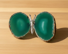 Load image into Gallery viewer, Brazilian agate butterfly specimen with turquoise green banded wings displayed on wood table, front view showing natural stone patterns and color variations