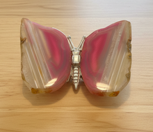 Load image into Gallery viewer, Brazilian agate butterfly with pink cores and cream edges, top view highlighting the symmetrical banding and silver metal body