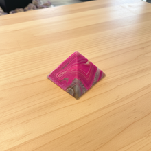 Load image into Gallery viewer, Side view of Brazilian agate pyramid with electrifying hot pink banding patterns flowing across the polished surface, 7cm base x 5cm height