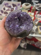 Load and play video in Gallery viewer, AMETHYST HAND POLISHED GEODE SPHERE