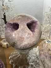 Load image into Gallery viewer, Front view of rainbow amethyst geode sphere revealing deep purple amethyst crystal cavity with darker interior and lighter rim crystals
