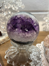 Load image into Gallery viewer, Brazilian amethyst geode sphere with deep purple crystal cluster interior on display stand
