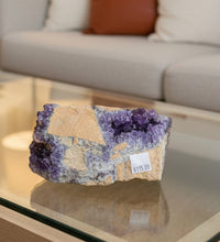 Load image into Gallery viewer, Close-up of amethyst display piece showing purple crystal formations and natural hematite inclusions

