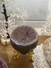 Load image into Gallery viewer, Hand-polished amethyst geode bowl on gold stand showing purple crystal druzy interior with smooth dark polished exterior
