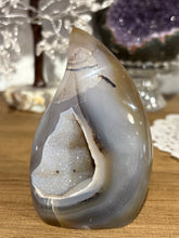 Load image into Gallery viewer, Brazilian agate flame polished specimen with smokey grey banding and internal crystal vug 9.5cm height
