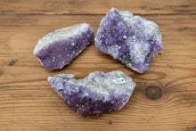 Load image into Gallery viewer, Image 1: Chunky Thunder Bay amethyst collection of 7 unique specimens with quartz and host rock, ranging 15cm to 5cm from Diamond Willow Mine

Image 2: Canadian amethyst bulk lot showing natural host rock matrix and quartz formations from Thunder Bay, Ontario

Image 3: Thunder Bay amethyst collection with chunky specimens featuring unique shapes, visible matrix, and some hematite inclusions

