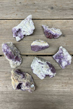 Load image into Gallery viewer, Image 1: Chunky Thunder Bay amethyst collection of 7 unique specimens with quartz and host rock, ranging 15cm to 5cm from Diamond Willow Mine

Image 2: Canadian amethyst bulk lot showing natural host rock matrix and quartz formations from Thunder Bay, Ontario

Image 3: Thunder Bay amethyst collection with chunky specimens featuring unique shapes, visible matrix, and some hematite inclusions


