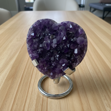 Load image into Gallery viewer, Purple amethyst heart specimen on metal display stand showing crystal formation and natural variations
