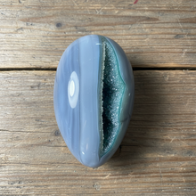 Load image into Gallery viewer, Brazilian agate geode egg showing natural banding patterns and polished exterior

