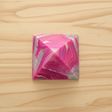 Load image into Gallery viewer, Top view of Brazilian agate pyramid showing the apex and natural hot pink banding patterns in polished Brazilian agate
