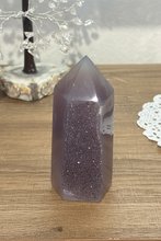 Load image into Gallery viewer, Angled view of two-tone agate tower showing sparkling druzy band running through translucent purple-grey crystal
