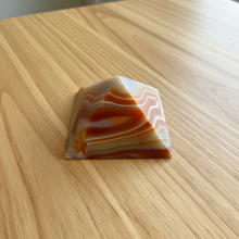 Load image into Gallery viewer, Top view of Brazilian agate pyramid showing the apex and graceful carnelian orange and cream banding patterns in polished agate, 7cm base
