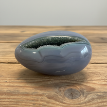 Load image into Gallery viewer, and paste manually:
Brazilian agate geode egg with blue-grey banding and greenish druzy crystal interior
